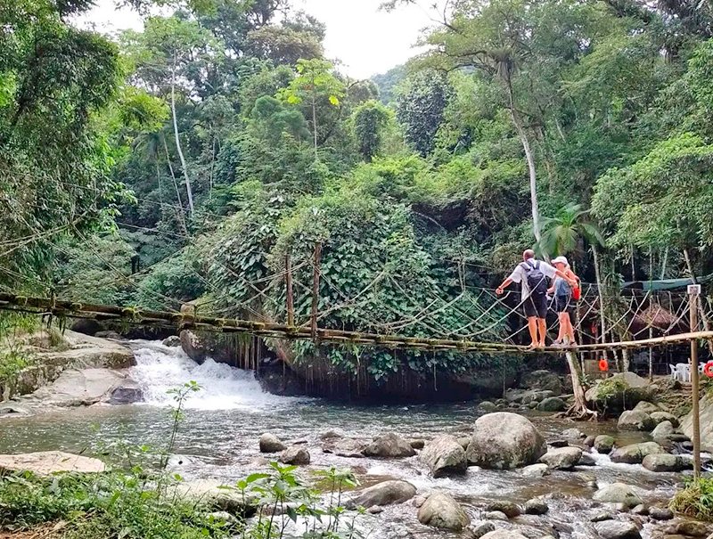 Hängebrücke aus Holz über den Fluss am Poço do Tarzan