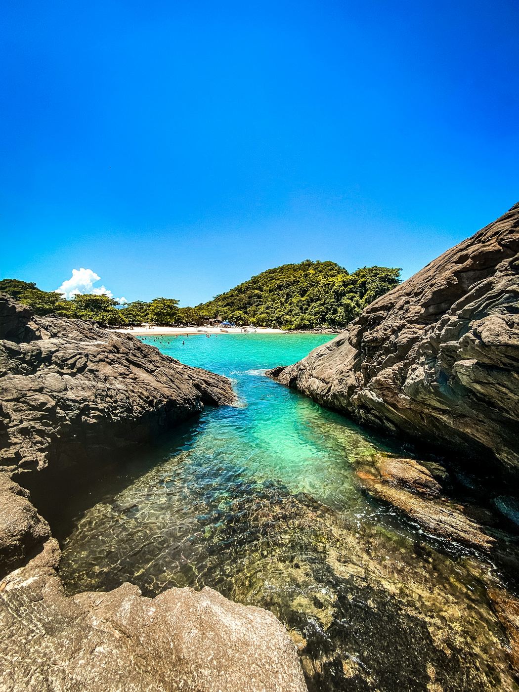 La piscina natural del Cachadaço: agua verde claro entre costas rocosas, en Trindade